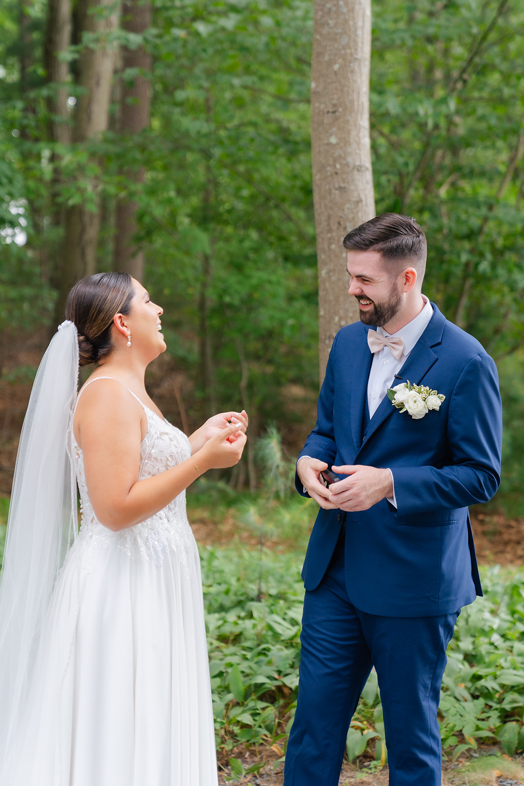 bride and groom laughing as they talk about their vows