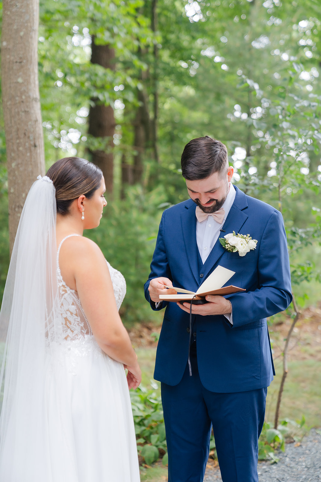 groom reading his vows to his bride