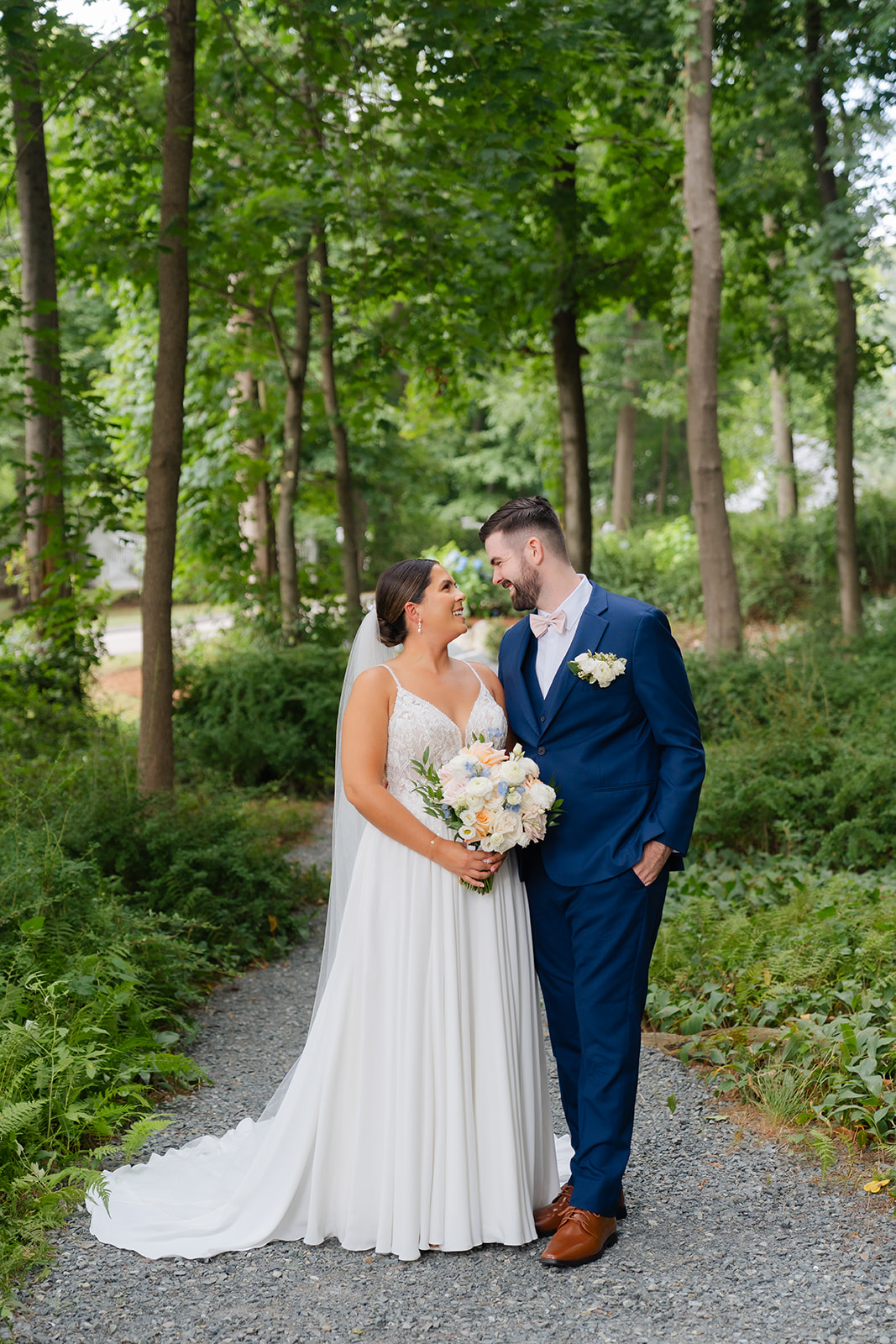 wedding photo of the couple with lush green outdoor background