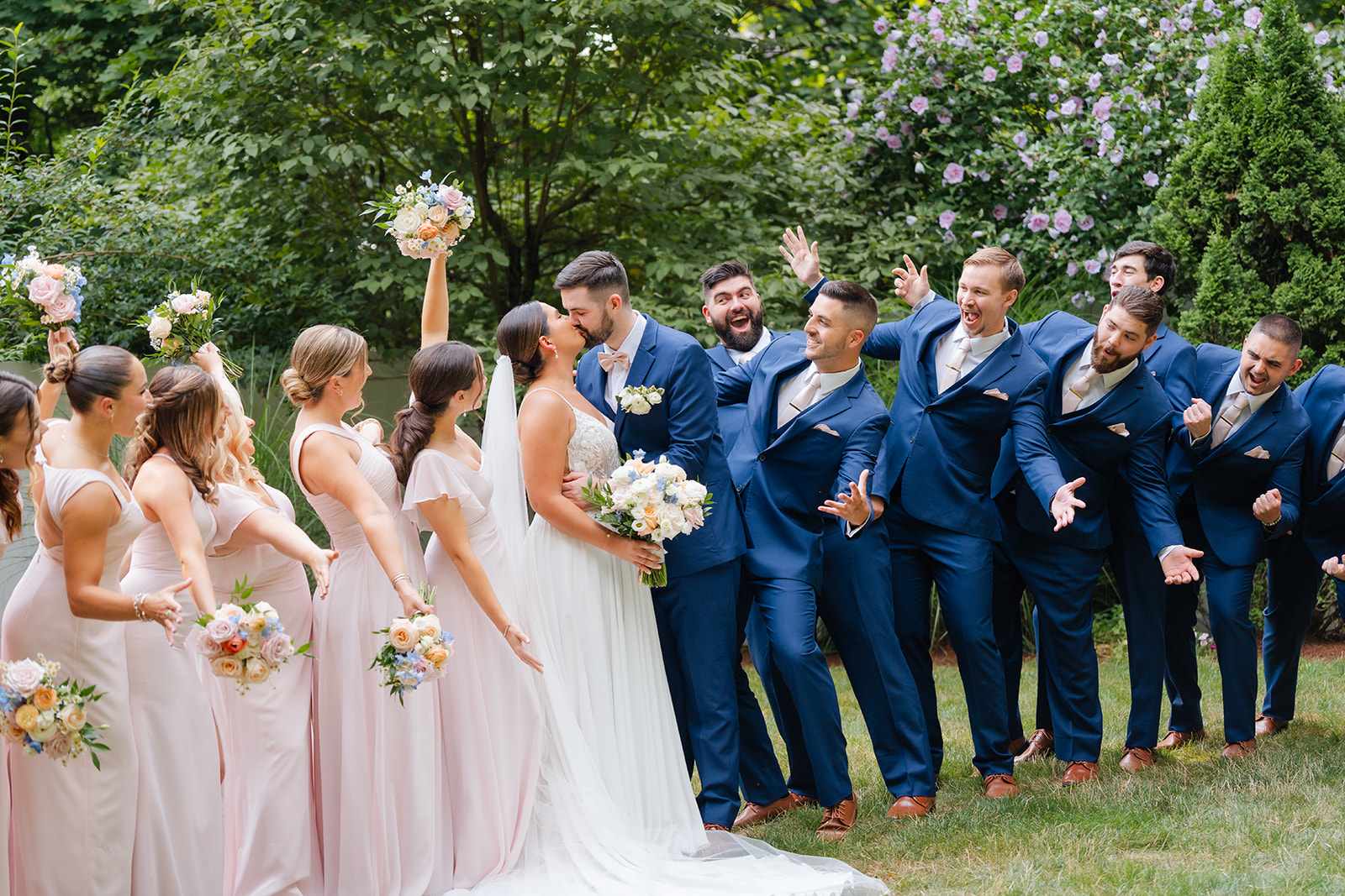 fun bridal party photo of the bride and groom and their bridesmaids and groomsmen 