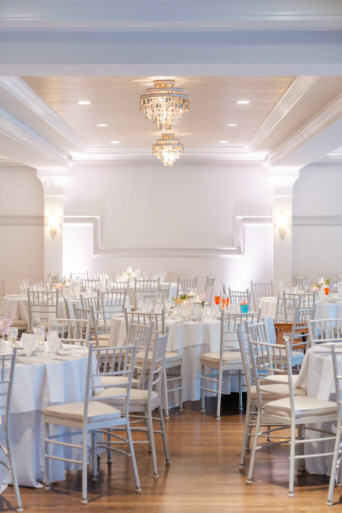 indoor ballroom wedding reception with minimal wedding table settings