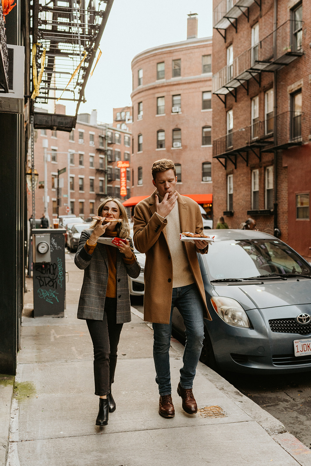 couple eating pizza for a fun engagement photoshoot