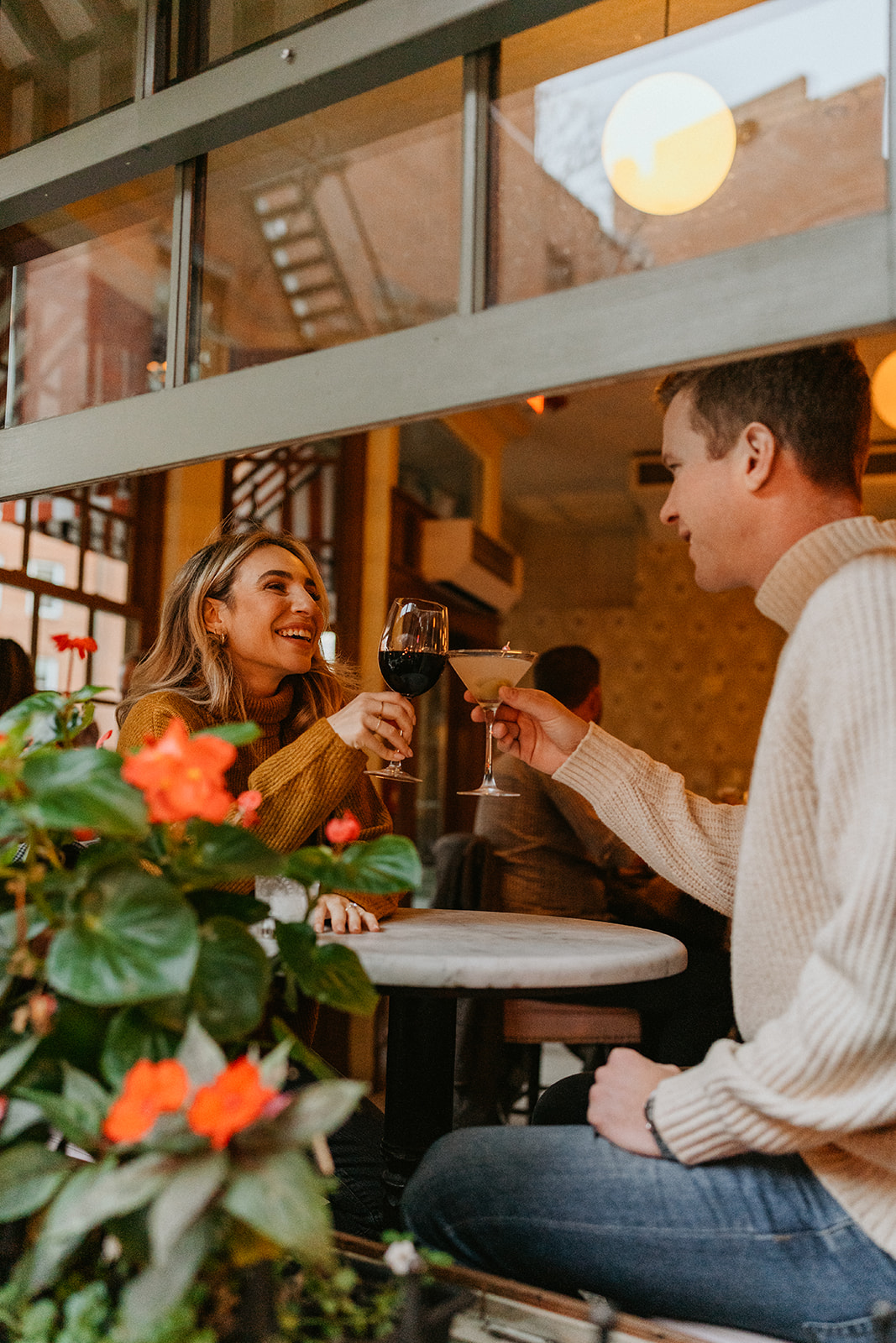 couple toasting with their drinks in the cafe