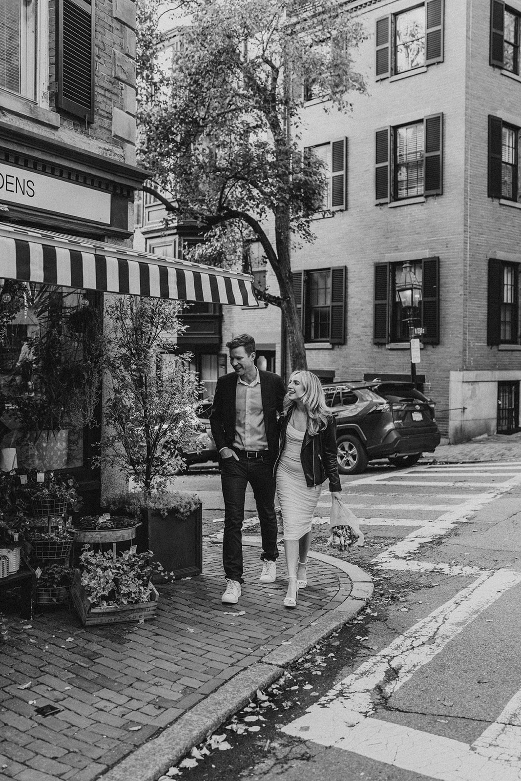 engaged couple walking candid at the street