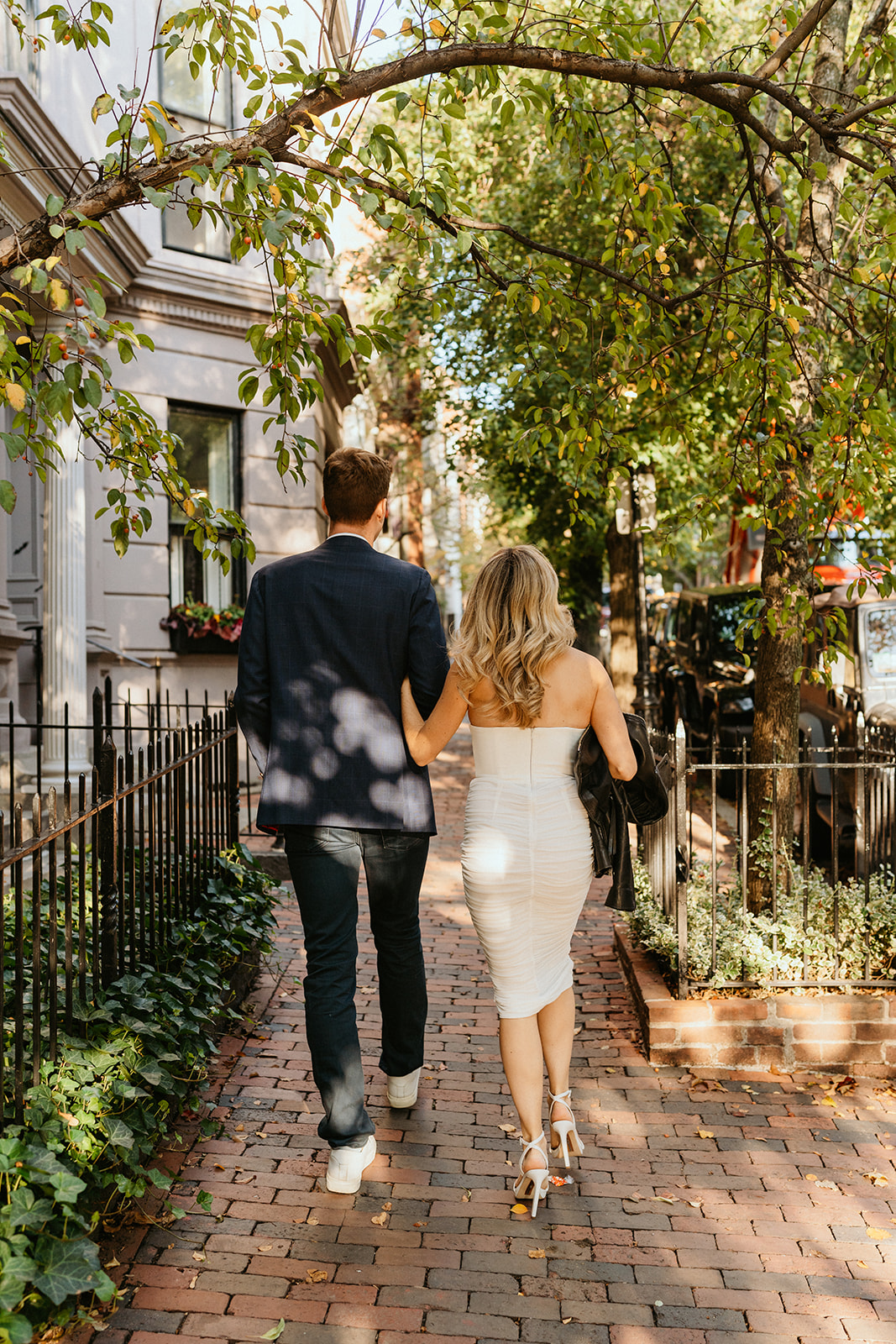 couple holding arms together walking at North End