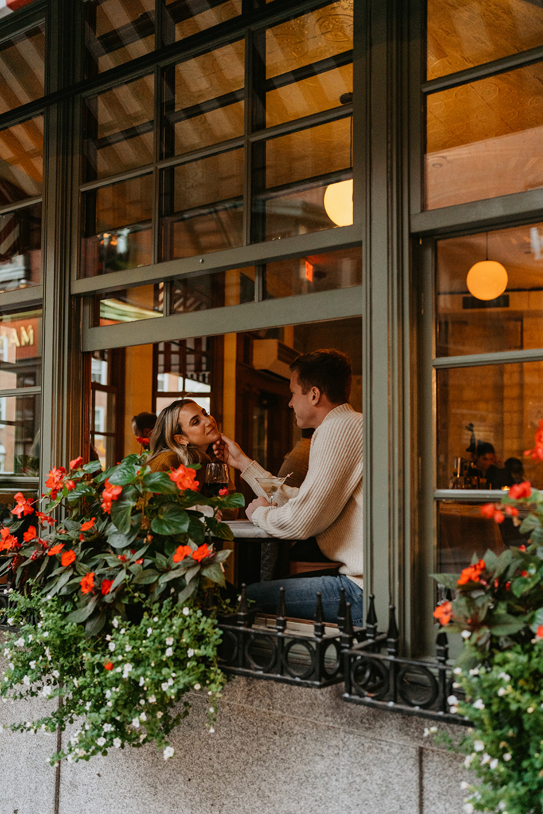 engaged couple sitting in a cozy cafe in Boston