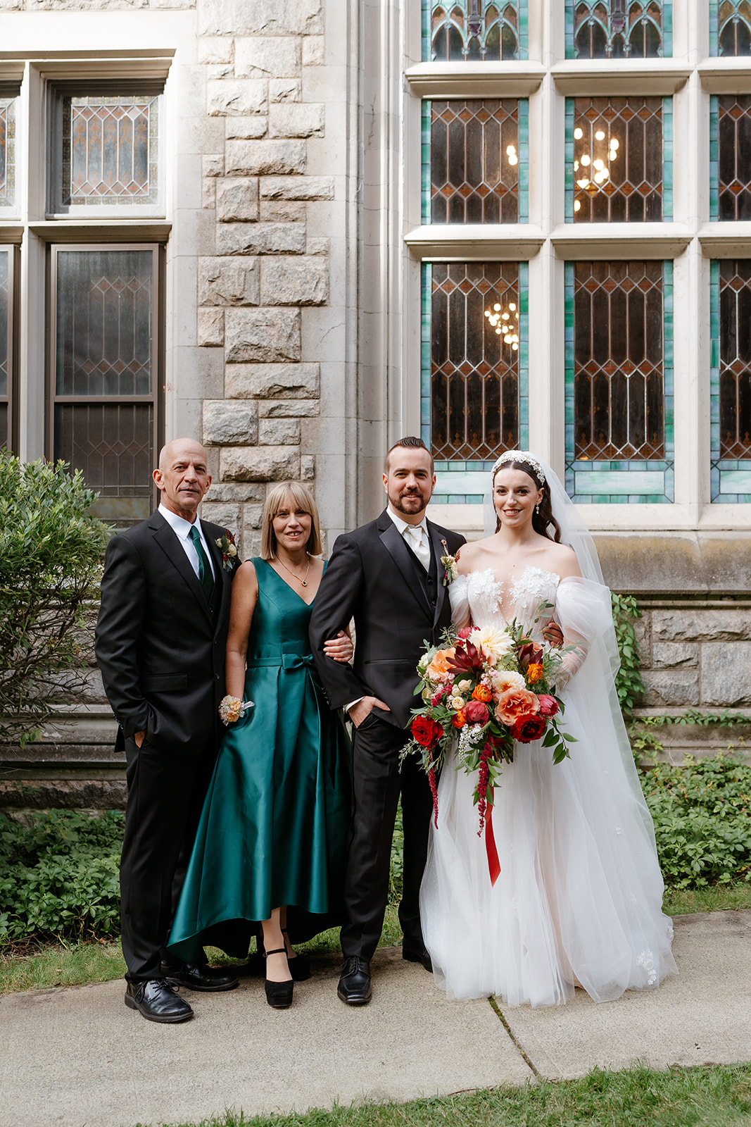 family wedding photo of bride and groom and his family