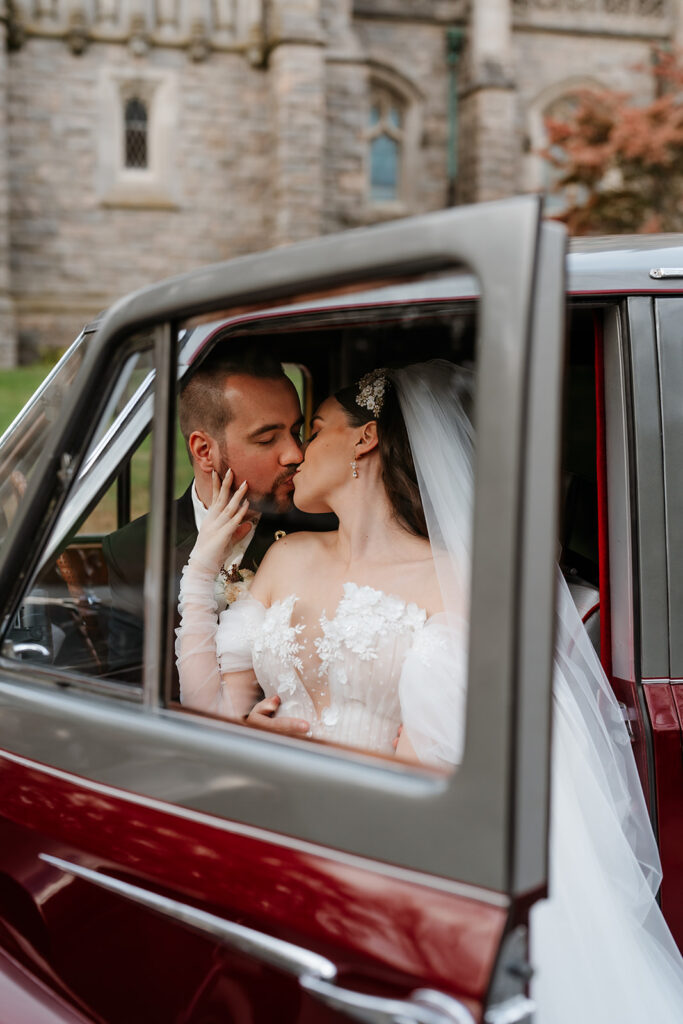 wedding couple kissing in a vintage car for their Massachusetts wedding