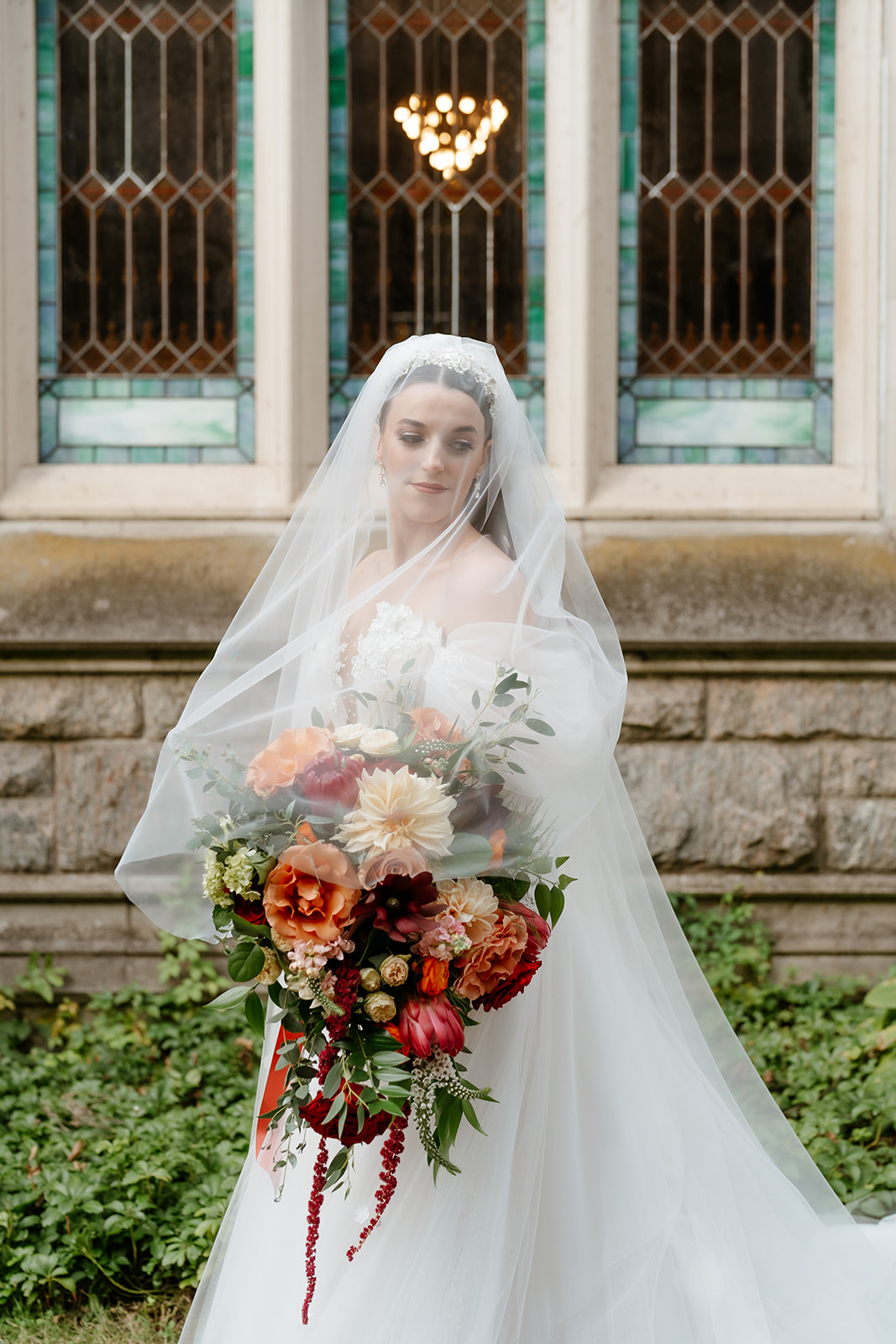 bridal portrait outdoors with her fall wedding bouquet 