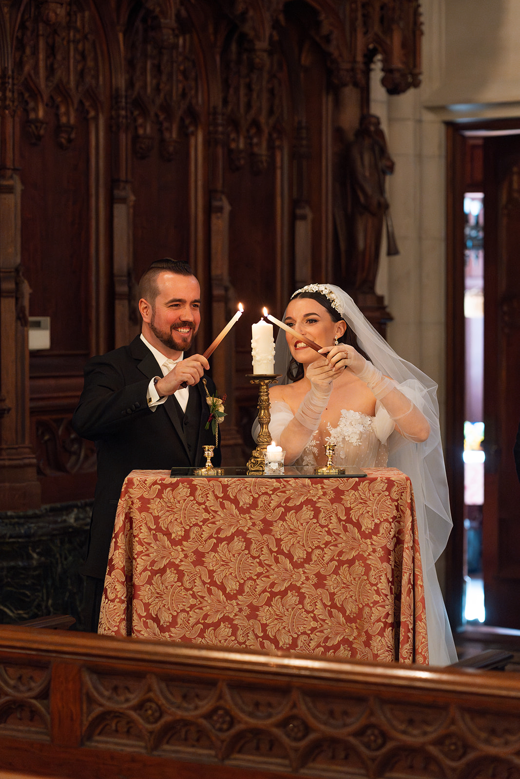 bride and groom lightening up a candle for their autumn wedding ceremony