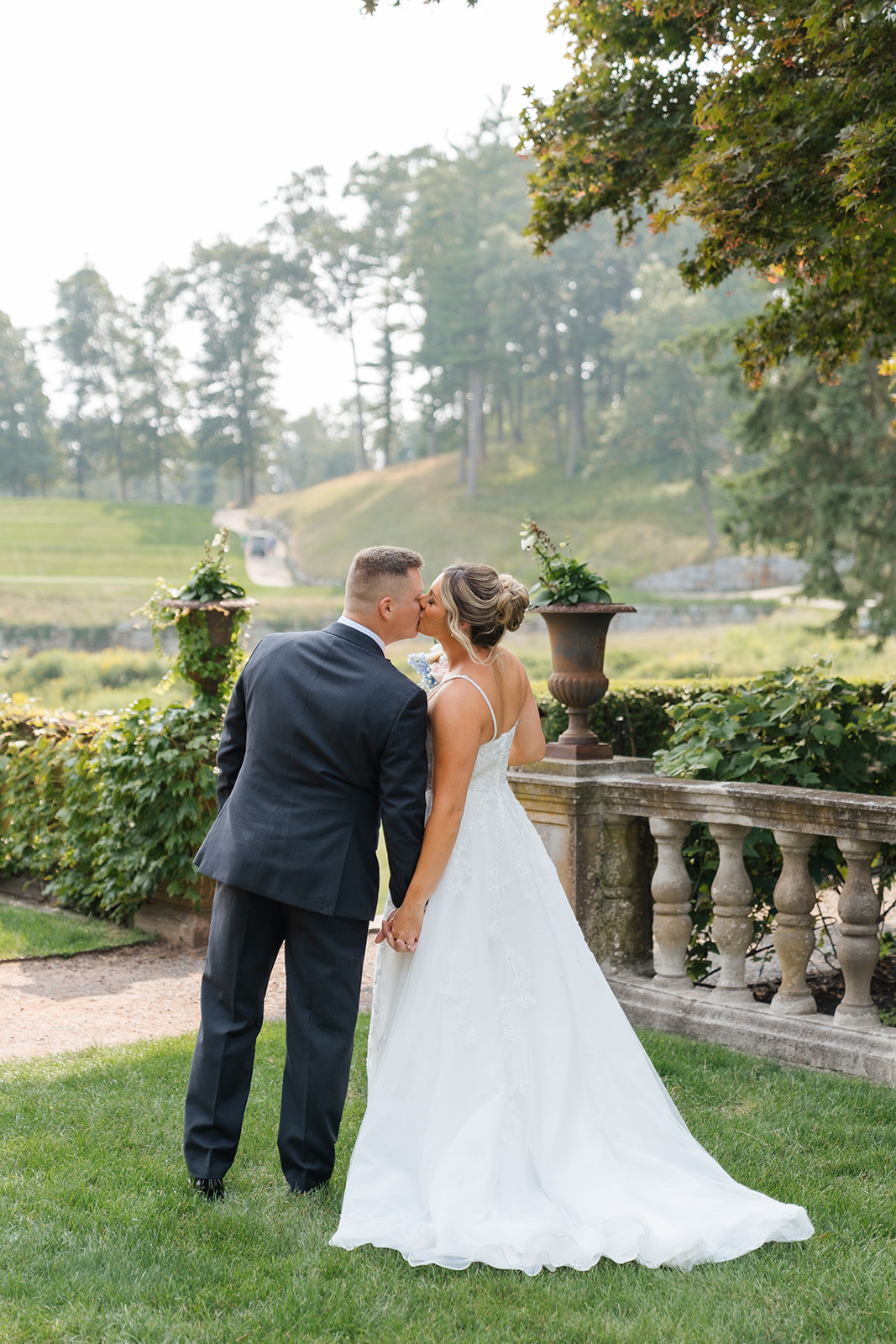 couple kisses at the garden at The Mansion on Turner Hill Wedding Venue 