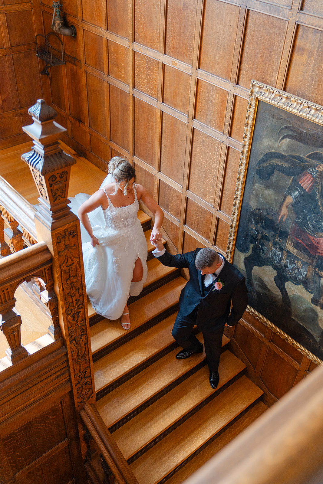 bride and groom holding hands going down the staircase at The Mansion on Turner Hill Wedding Venue 