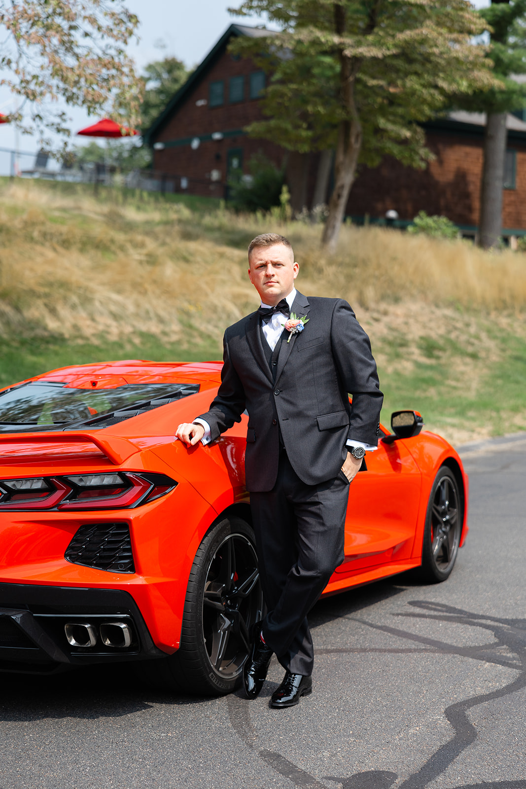 wedding portrait of the groom and his modern car 