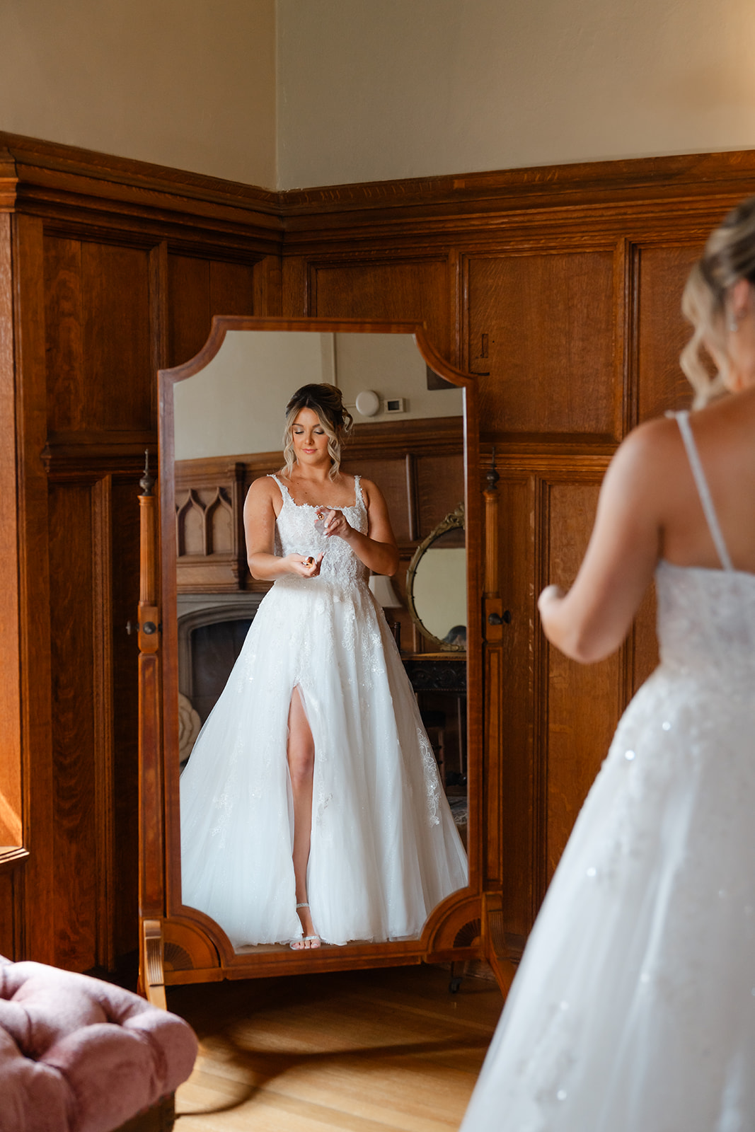 getting ready photo of the bride putting perfume on