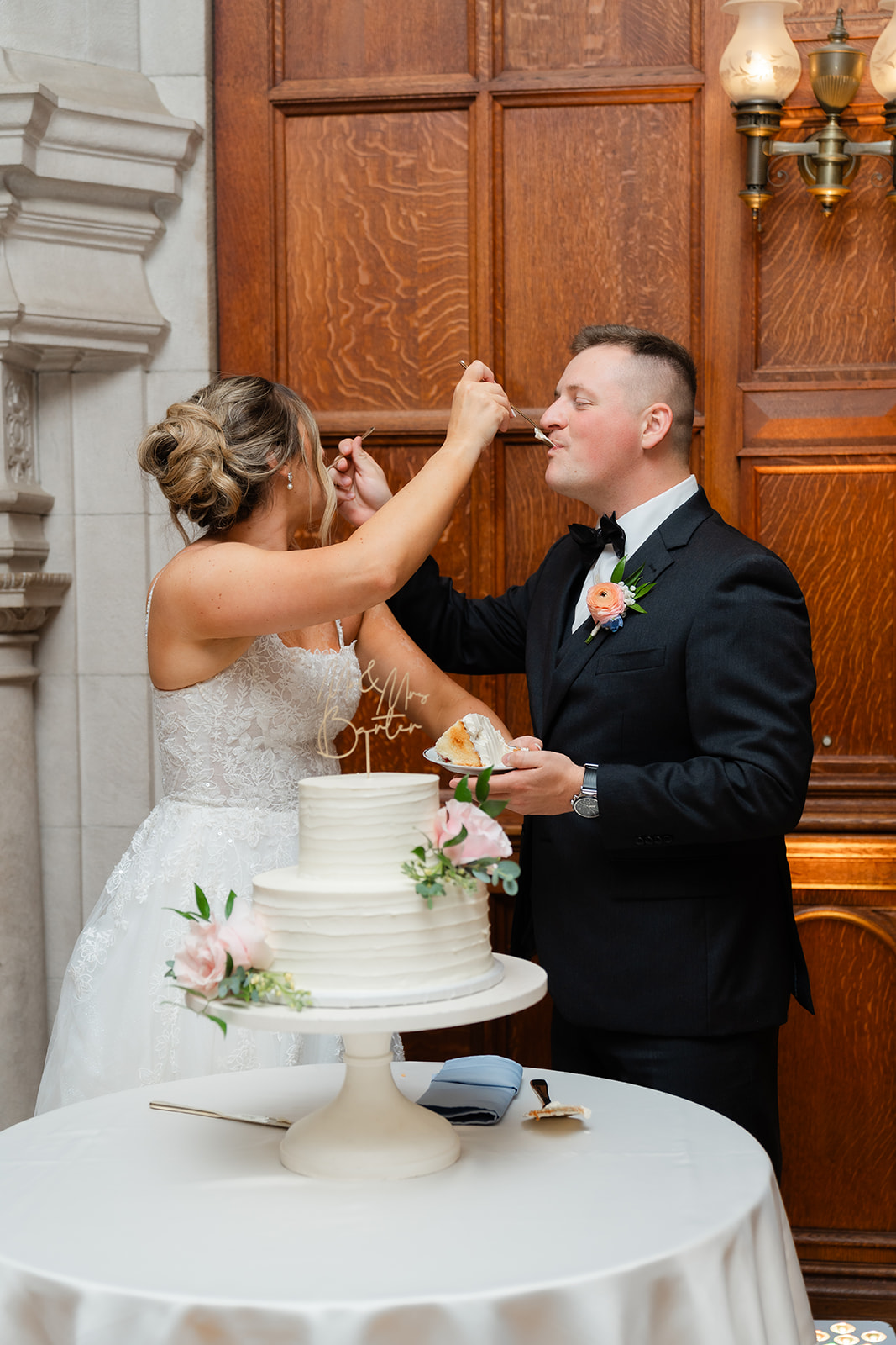 bride and groom feeding cake to each other