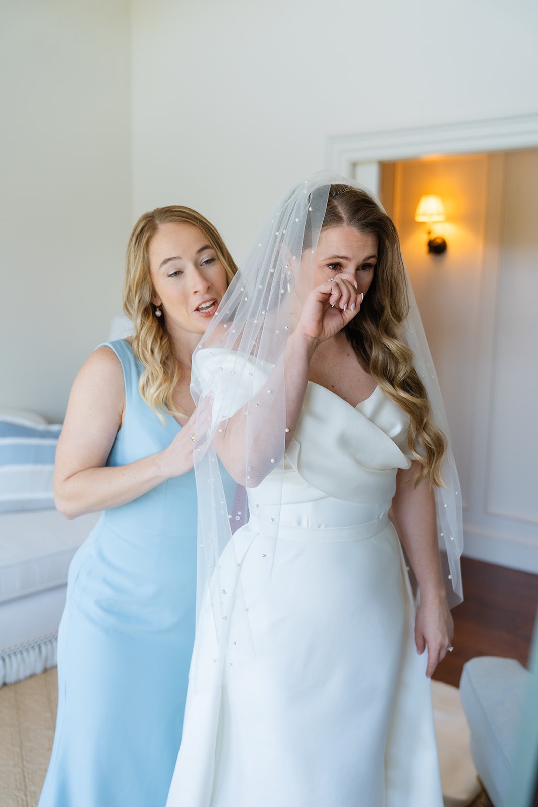 bride getting emotional getting ready captured by a boston wedding photographer