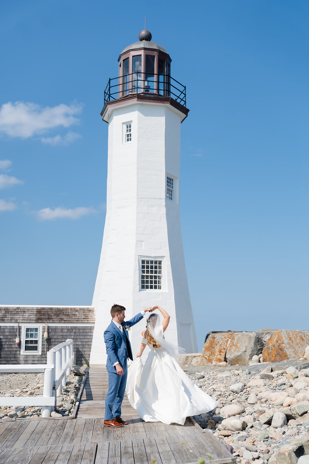 bride and groom dancing in front of the lighthouse 