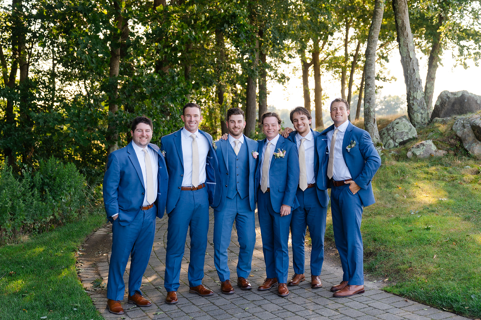 groom and groomsmen smiling for a portrait