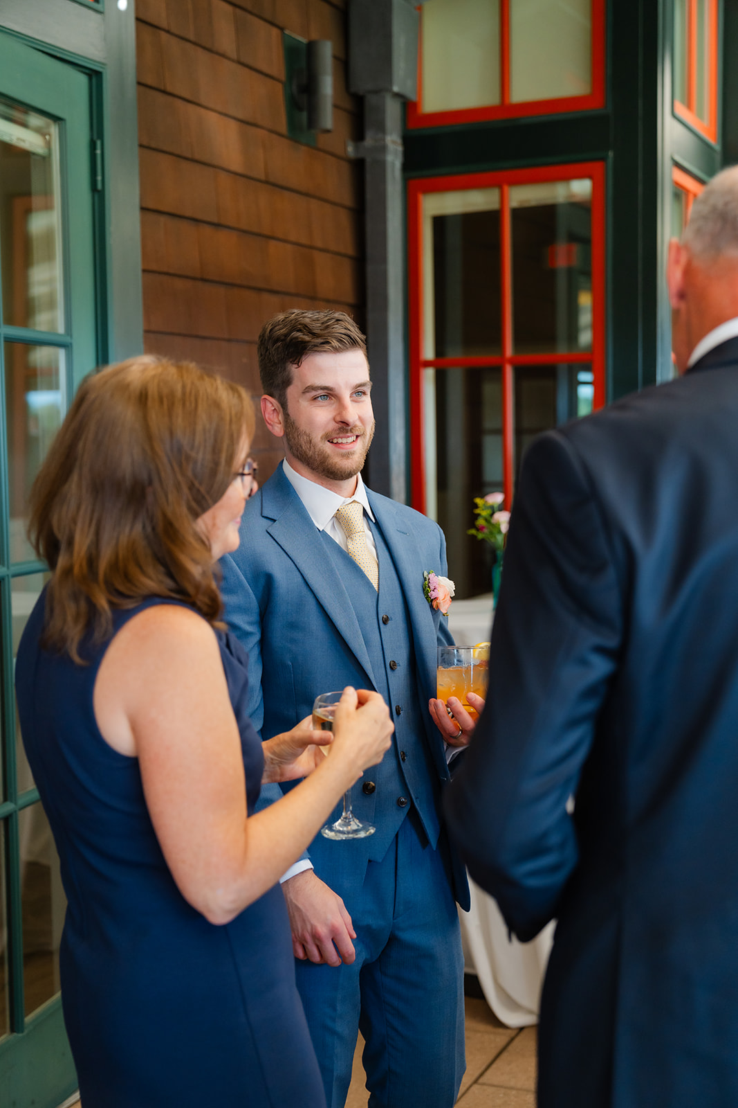 groom speaking with the guest during cocktail hour