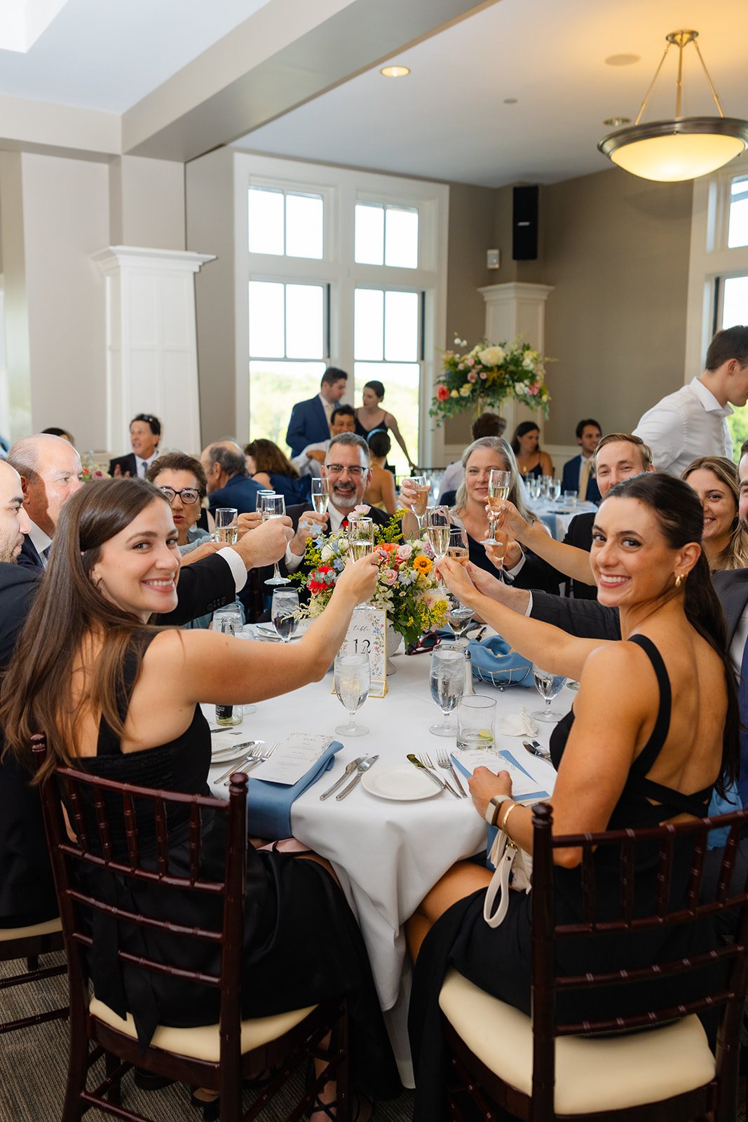 guests raising their glass for a toast during the wedding reception