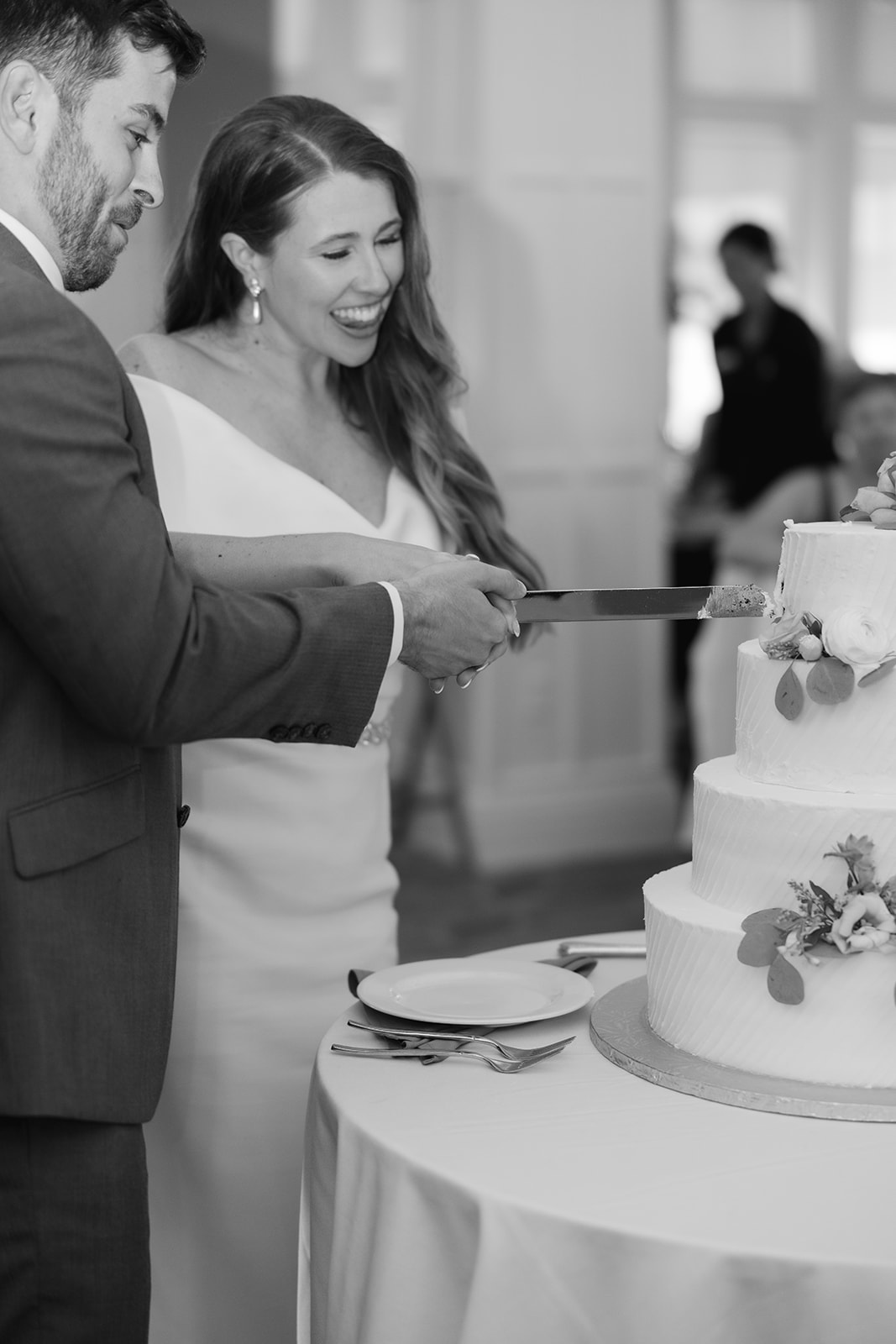 intimate wedding photo of the bride and groom cutting the wedding cake