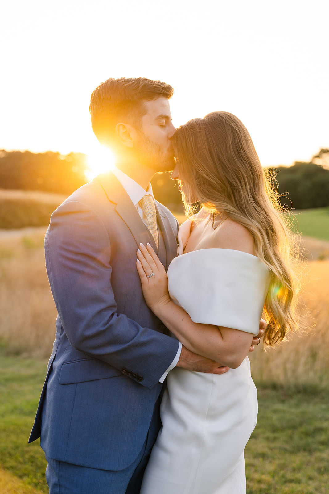 romantic wedding photo of bride and groom during golden hour