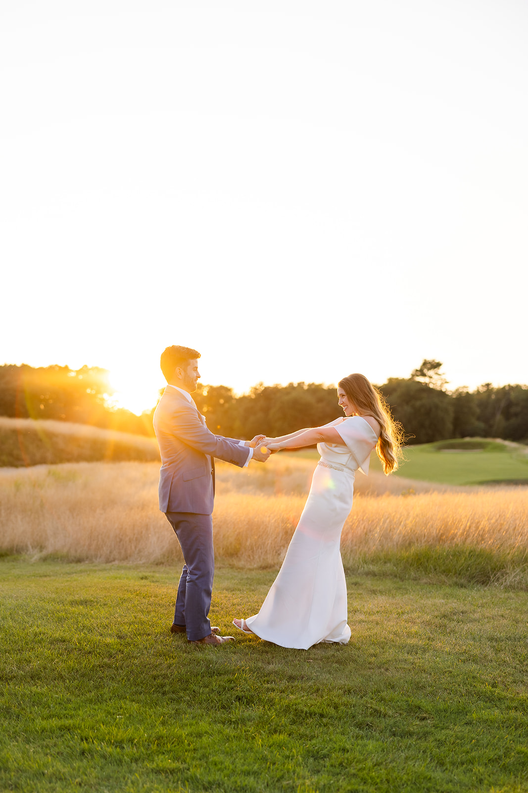 bride and groom dancing during golden hour