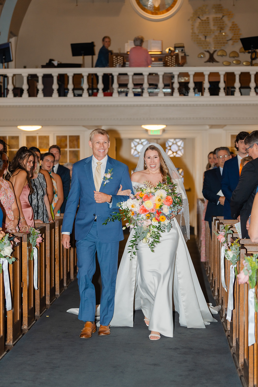 bride walking down the aisle with her father