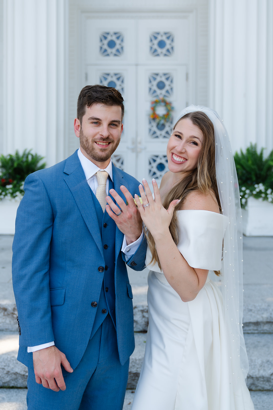 bride and groom showing off their ring