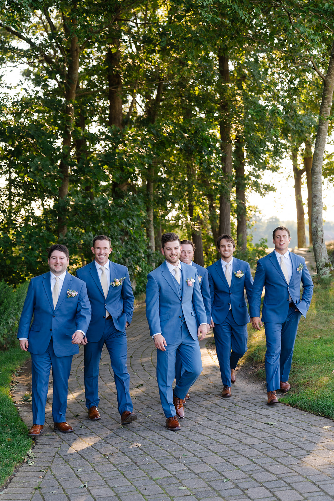 candid photo of the groom and groomsmen walking 