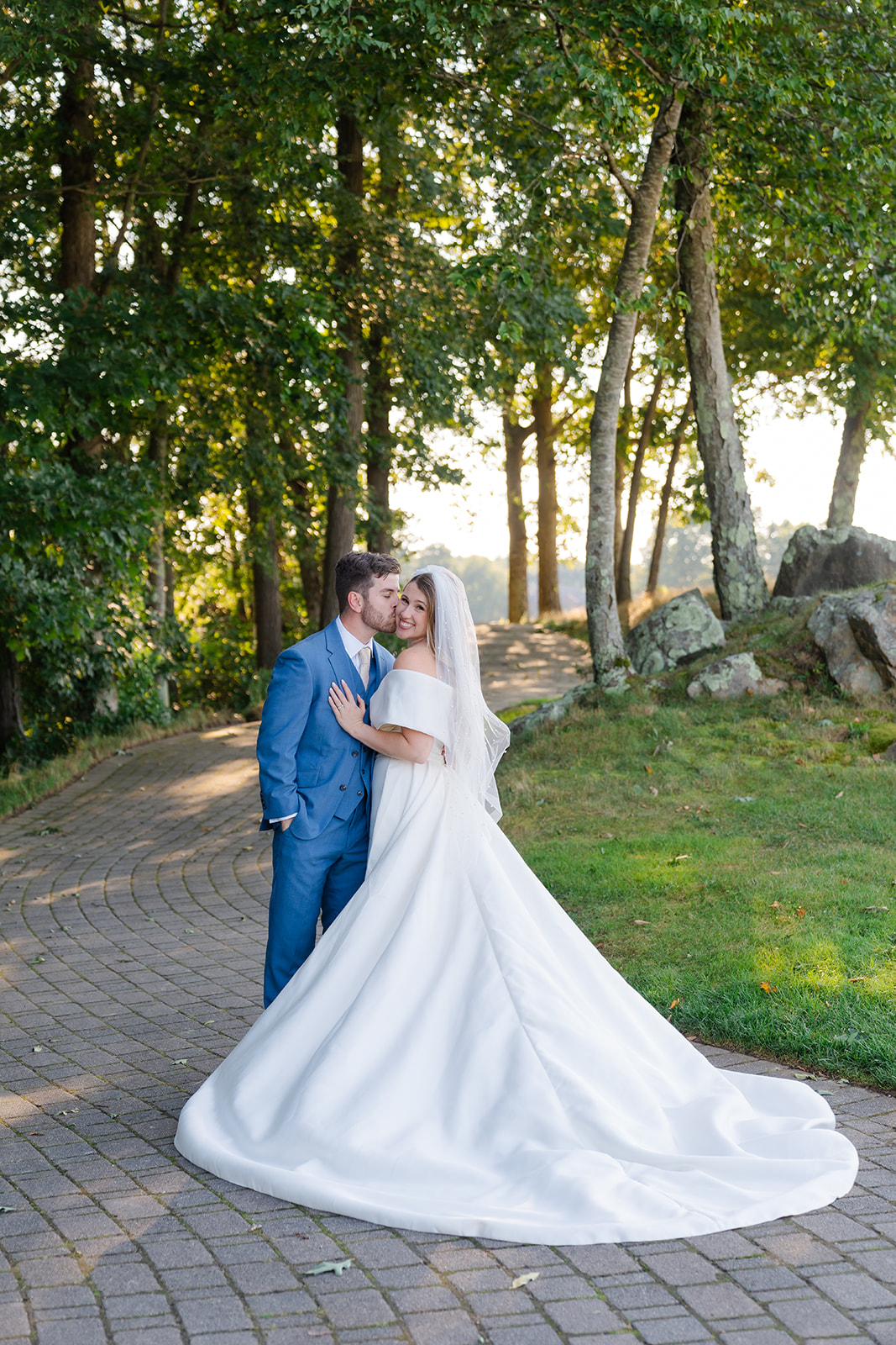 groom kissing the bride on the cheek