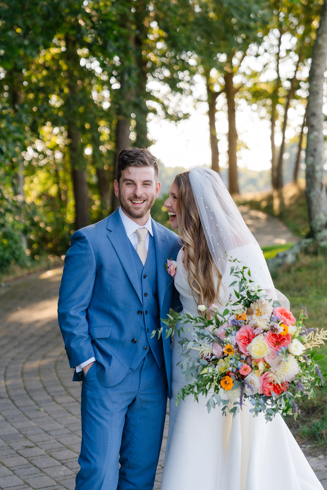 candid wedding photo of the bride and groom laughing 