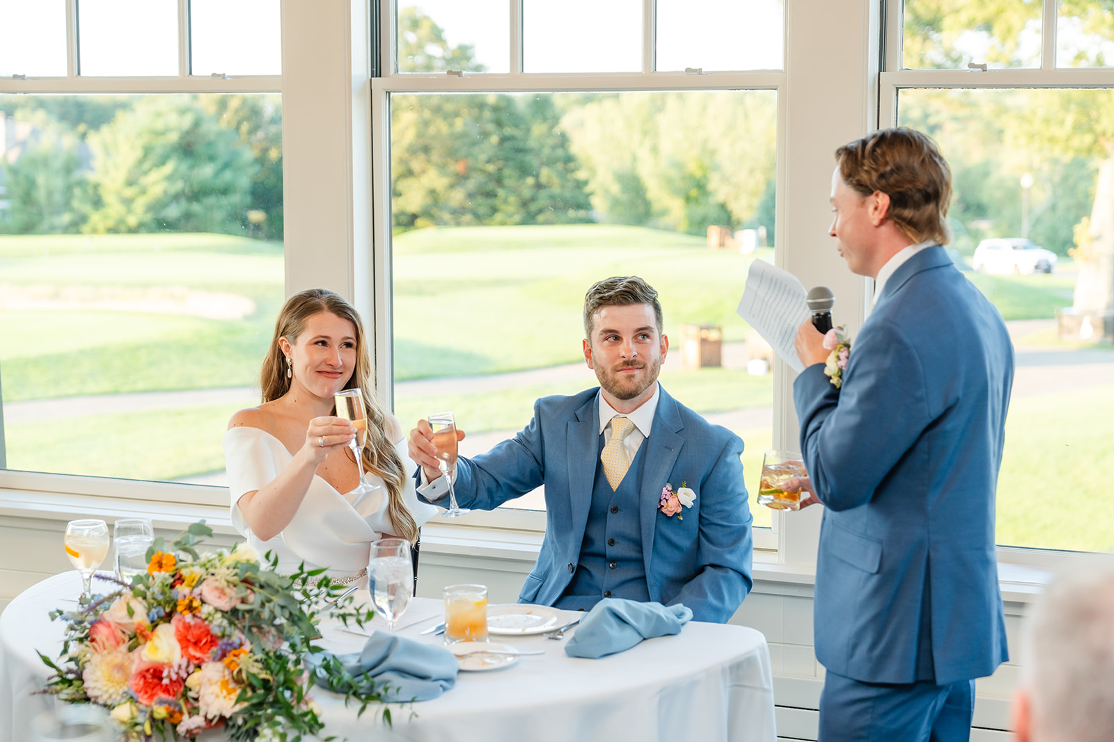 a photo of the best man giving his speech during the wedding reception