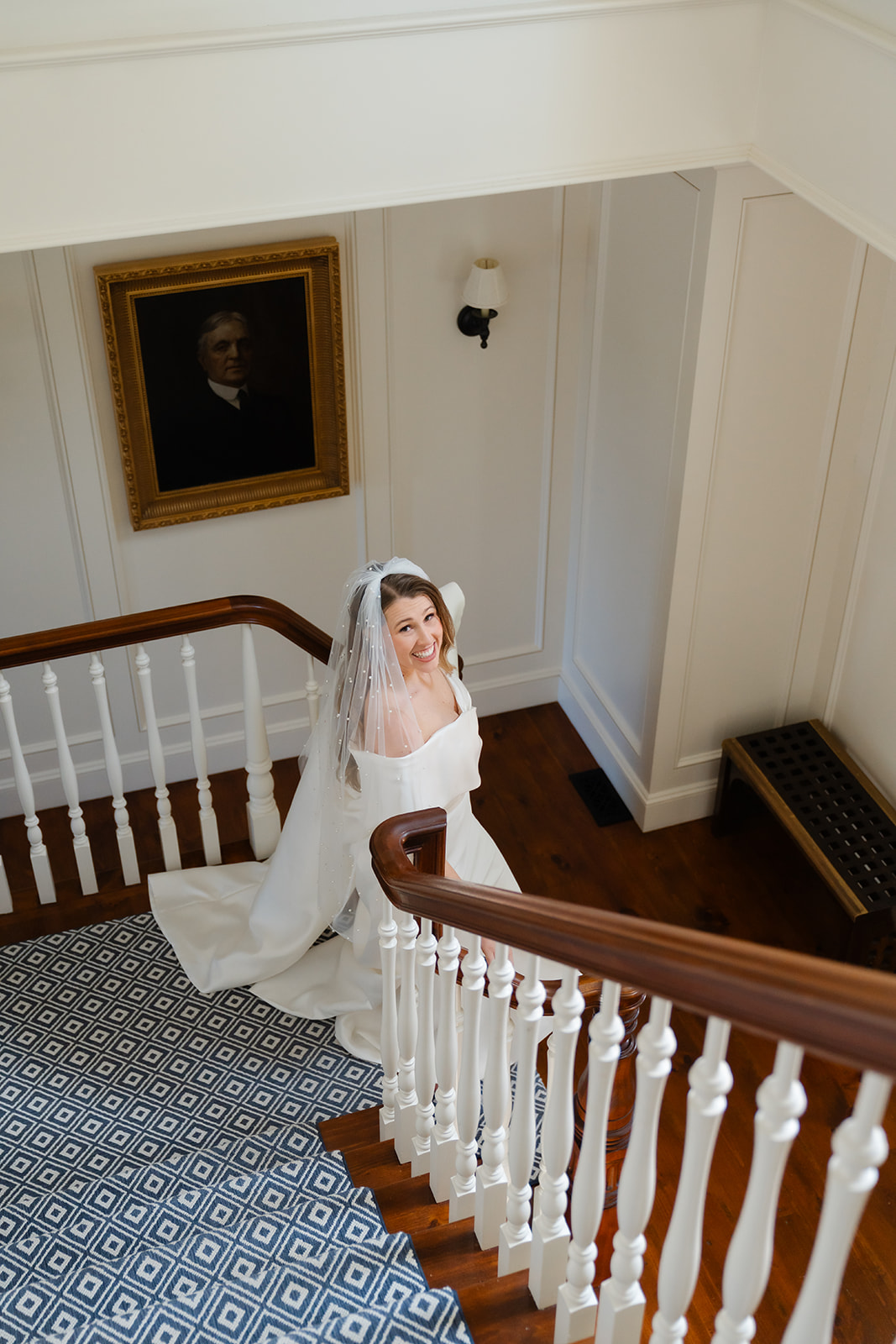 bride smiling walking down the staircase in a boston wedding venue