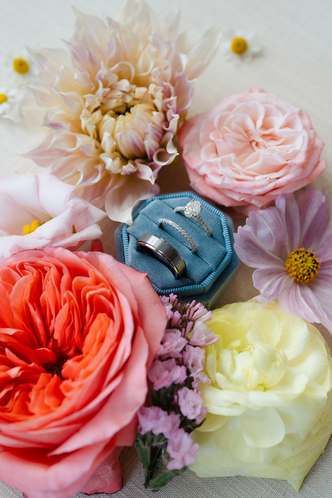 flay lay wedding photo of the wedding ring surrounded by flowers