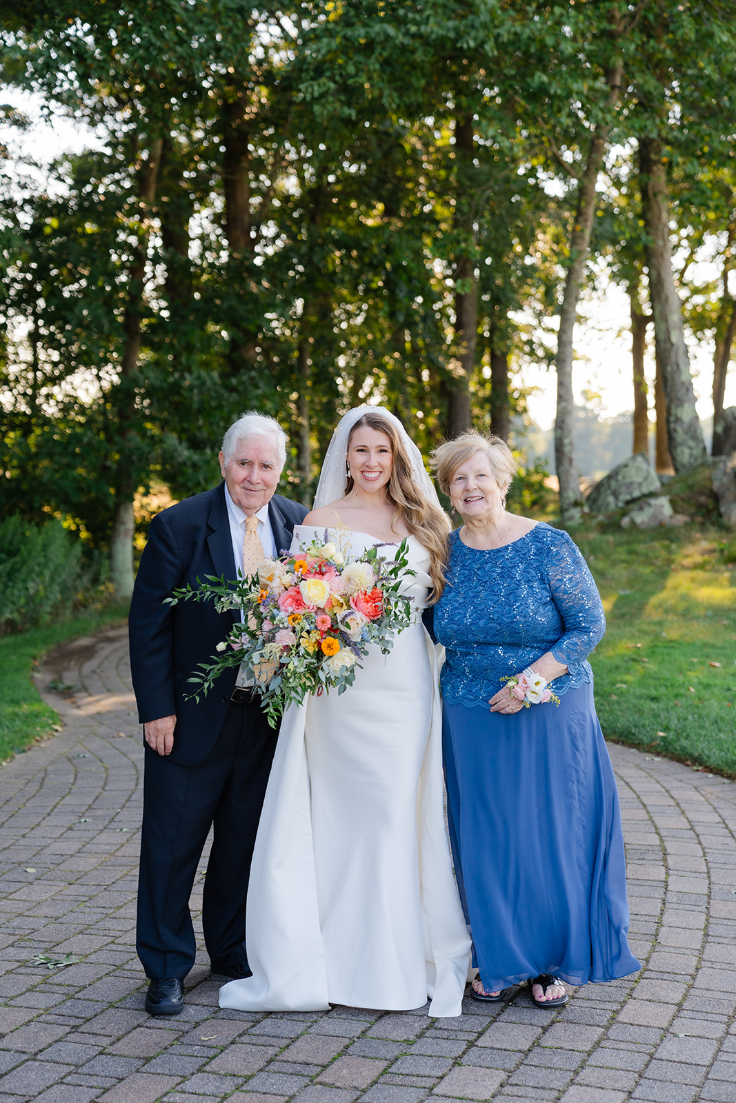 a wedding portrait of the bride and her grandparents