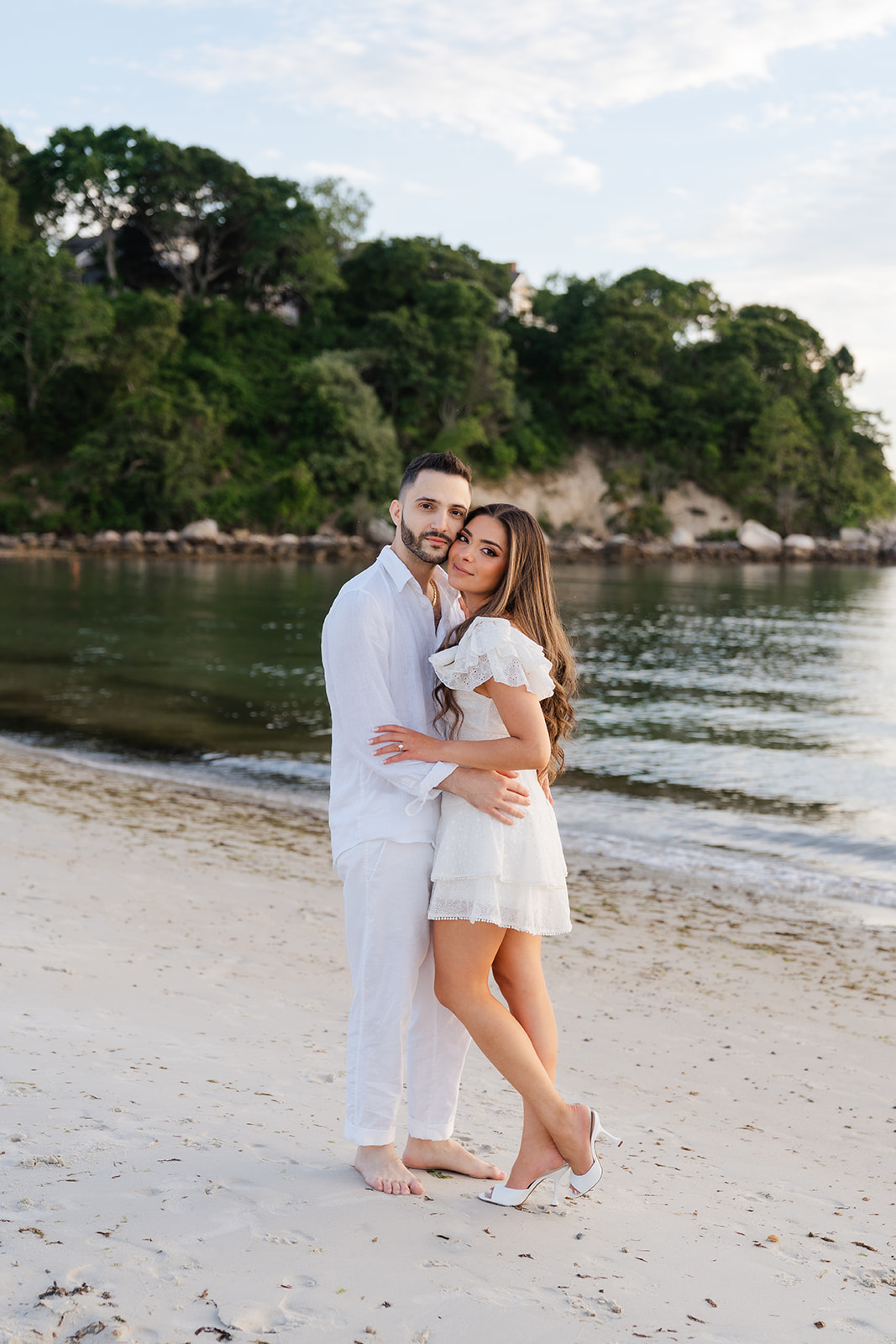 A romantic moment between the couple as they gently touch foreheads, embracing each other on Old Silver Beach, captured beautifully in this Cape Cod engagement photo.