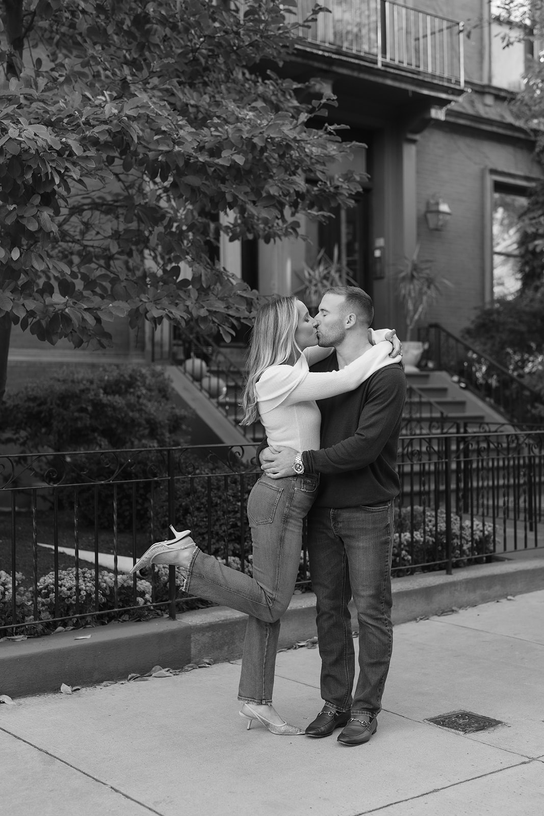 Black and white photo of a couple kissing