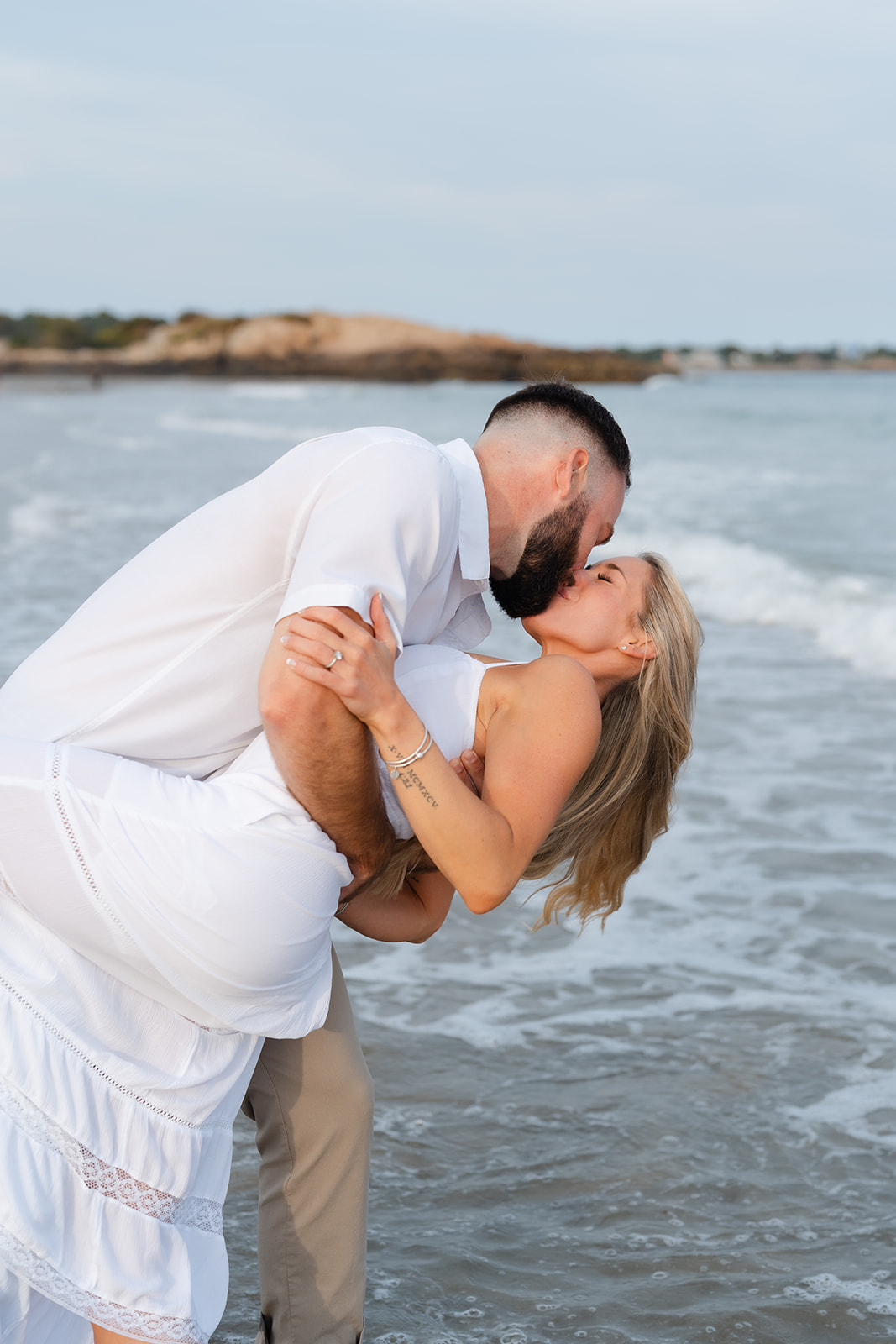 A couple sharing a passionate kiss on the beach