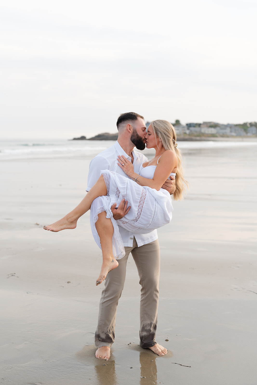 A couple sharing a passionate kiss on the beach