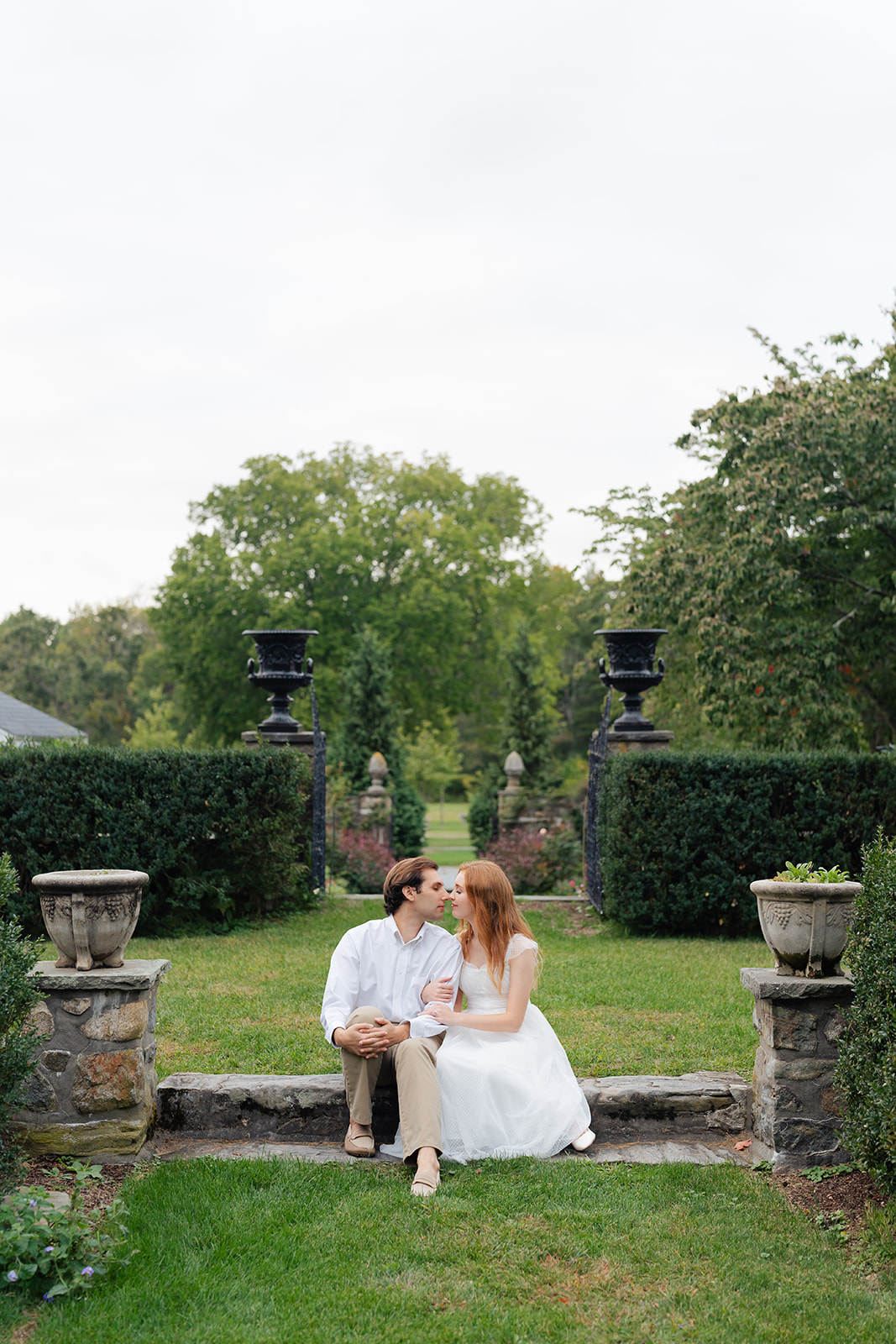 Sitting together on a stone step, the couple shares a quiet moment, gazing lovingly into each other's eyes. This intimate and relaxed pose shows how capturing personal connections during your engagement session can make your photos stand out.