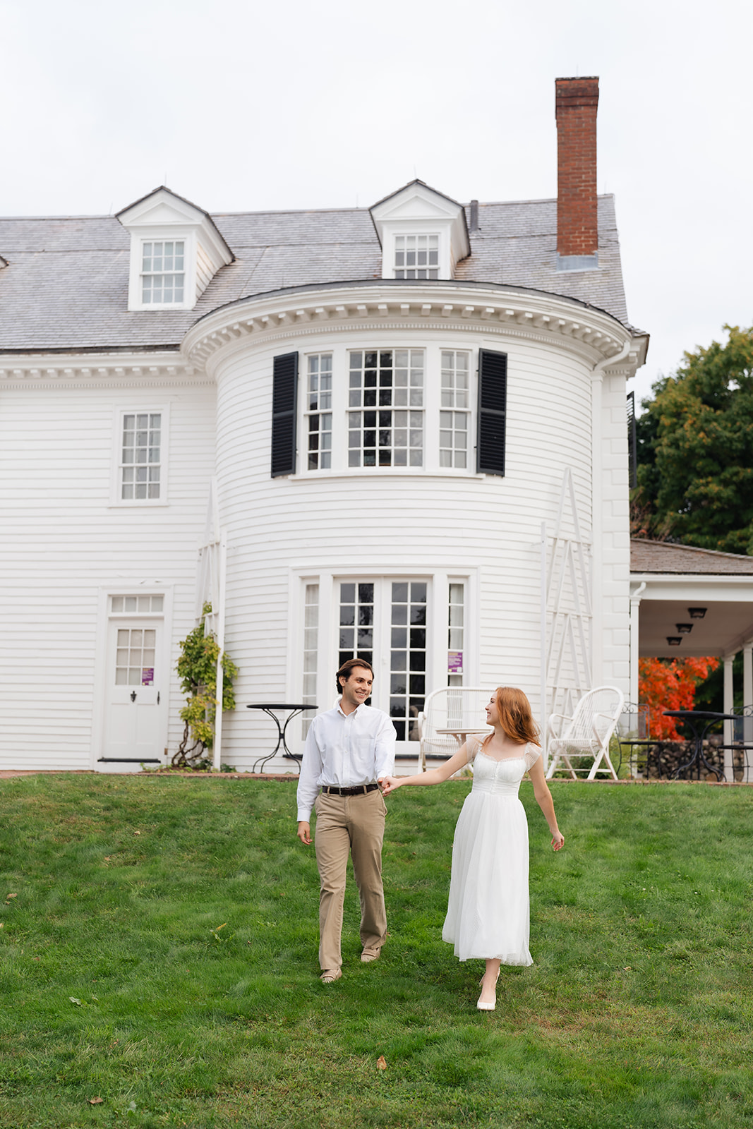 A couple walking hand-in-hand across the garden at Stevens-Coolidge House & Gardens, showcasing their personal and unique engagement shoot ideas.